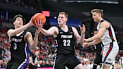 Jan 2, 2025; Spokane, Washington, USA; Portland Pilots forward Austin Rapp (22) rebounds against Gonzaga Bulldogs forward Ben Gregg (33) in the first half at Spokane Veterans Memorial Arena. Mandatory Credit: James Snook-Imagn Images