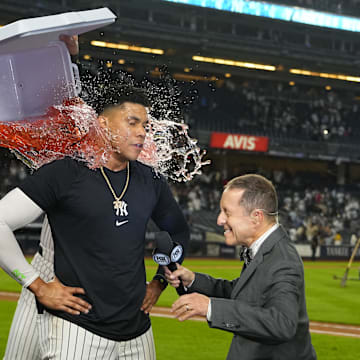 Sep 12, 2024; Bronx, New York, USA; New York Yankees shortstop Anthony Volpe (11) and center fielder Aaron Judge (99) dump gatorade on right fielder Juan Soto (22) for getting the game winning hit while being interviewed by Fox Broadcaster Ken Rosenthal after the game against the Boston Red Sox at Yankee Stadium.