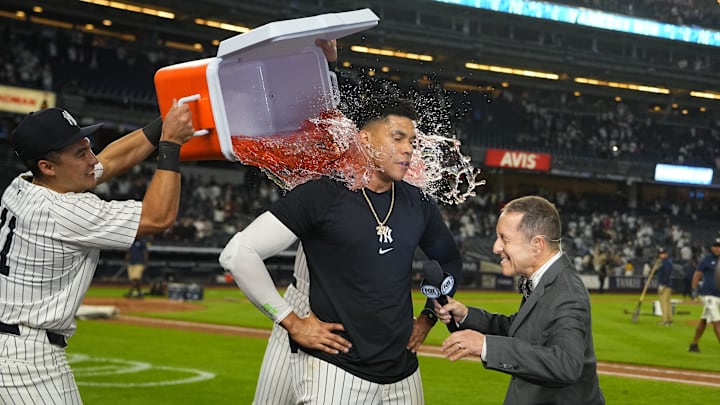 Sep 12, 2024; Bronx, New York, USA; New York Yankees shortstop Anthony Volpe (11) and center fielder Aaron Judge (99) dump gatorade on right fielder Juan Soto (22) for getting the game winning hit while being interviewed by Fox Broadcaster Ken Rosenthal after the game against the Boston Red Sox at Yankee Stadium.