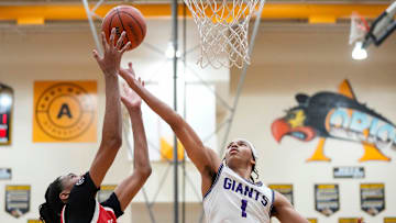 Ben Davis Giants Justin Parks (1) reaches for the ball against Pike Red Devils center Isaiah Hill (30) on Friday, March 7, 2025, during the IHSAA boys basketball sectional semifinal at Avon High School in Avon. Ben Davis defeated Pike with a close score of 43-41 to advance to the Sectional 11 final.