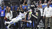 Dec 28, 2024; San Antonio, TX, USA; Colorado Buffaloes wide receiver Travis Hunter (12) runs with the ball as Brigham Young Cougars cornerback Mory Bamba (4) attempts to make a tackle during the second quarter at Alamodome. Mandatory Credit: Troy Taormina-Imagn Images