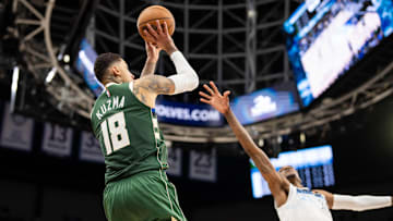 Feb 12, 2025; Minneapolis, Minnesota, USA; Milwaukee Bucks forward Kyle Kuzma (18) shoots against Minnesota Timberwolves forward Jaden McDaniels (3) in the fourth quarter at Target Center. Mandatory Credit: Brad Rempel-Imagn Images