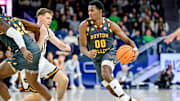 Jan 13, 2025; South Bend, Indiana, USA; Boston College Eagles guard Chas Kelley III (00) dribbles as Notre Dame Fighting Irish guard Matt Allocco (41) defends in the first half at the Purcell Pavilion. Mandatory Credit: Matt Cashore-Imagn Images