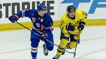 Aug 2, 2024; Plymouth, MI, USA; USA’s forward Colin Ralph (11) battles for position with Sweden's forward Melvin Fernstrom (12) during the second period of the 2024 World Junior Summer Showcase at USA Hockey Arena. Mandatory Credit: David Reginek-Imagn Images