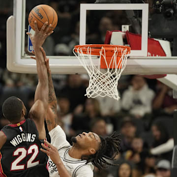 Oct 30, 2025; San Antonio, Texas, USA; San Antonio Spurs guard Stephon Castle (5) fouls Miami Heat forward Andrew Wiggins (22) during the first half at Frost Bank Center. Mandatory Credit: Scott Wachter-Imagn Images