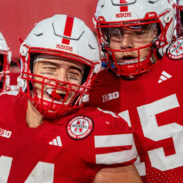 Running back Emmett Johnson, tight end Luke Lindenmeyer and quarterback Dylan Raiola celebrate after a touchdown against the Akron Zips.