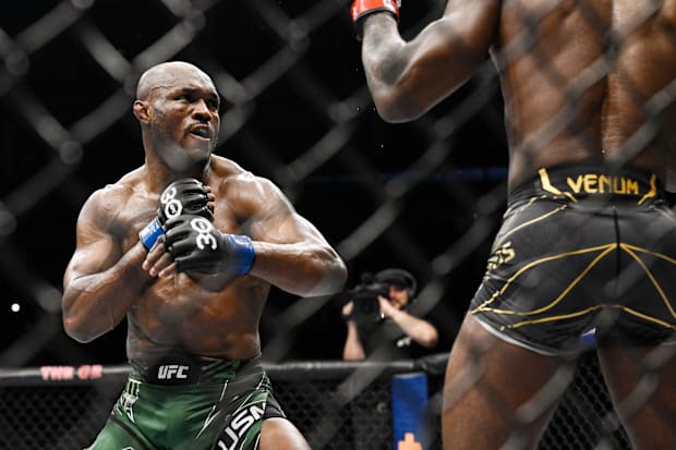 Leon Edwards (red gloves) fights Kamaru Usman (blue gloves) during UFC 286 at O2 Arena. 
