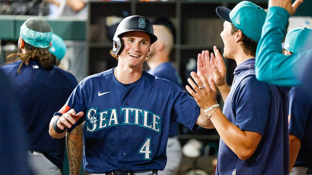 Jul 24, 2026; Arlington, Texas, USA; Seattle Mariners shortstop Colt Emerson (4) is congratulated after coming in to score during the fifth inning against the Texas Rangers at Globe Life Field. Mandatory Credit: Andrew Dieb-Imagn Images