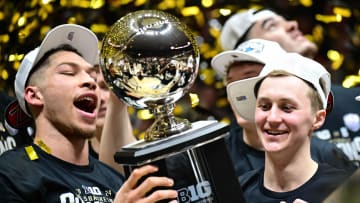 Purdue Boilermakers forward Mason Gillis and guard Fletcher Loyer celebrate with the Big Ten Champions Trophy 