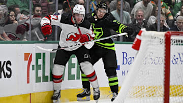 Mar 14, 2024; Dallas, Texas, USA; Dallas Stars center Logan Stankoven (11) checks New Jersey Devils defenseman Simon Nemec (17) during the second period at the American Airlines Center. Mandatory Credit: Jerome Miron-Imagn Images