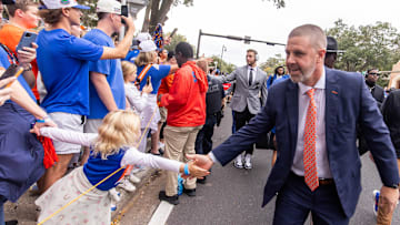 Florida Gators head coach Billy Napier shakes hands with fan after exiting the bus during Gator Walk before the game against the Kentucky Wildcats at Ben Hill Griffin Stadium in Gainesville, FL on Saturday, October 19, 2024. [Doug Engle/Gainesville Sun]