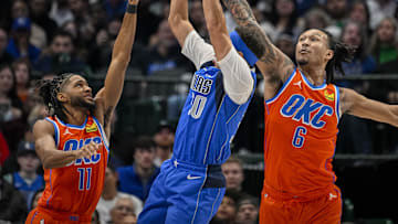 Dec 2, 2023; Dallas, Texas, USA; Dallas Mavericks guard Seth Curry (30) attempts to shoot over Oklahoma City Thunder guard Isaiah Joe (11) and forward Jaylin Williams (6) during the second quarter at the American Airlines Center. Mandatory Credit: Jerome Miron-Imagn Images