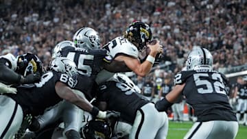 Nov 2, 2025; Paradise, Nevada, USA; Jacksonville Jaguars quarterback Trevor Lawrence (16) jumps to score a touchdown during the second half against the Las Vegas Raiders at Allegiant Stadium. Mandatory Credit: Kirby Lee-Imagn Images
