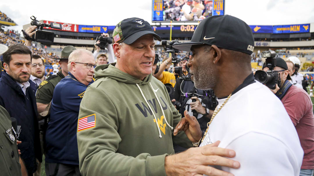 Nov 8, 2025; Morgantown, West Virginia, USA; West Virginia Mountaineers head coach Rich Rodriguez talks with Colorado Buffaloes head coach Deion Sanders after the game at Milan Puskar Stadium. Mandatory Credit: Ben Queen-Imagn Images