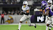 Nov 3, 2024; Minneapolis, Minnesota, USA; Indianapolis Colts safety Nick Cross (20) returns an interception off Minnesota Vikings quarterback Sam Darnold (not pictured) during the fourth quarter at U.S. Bank Stadium. Mandatory Credit: Jeffrey Becker-Imagn Images