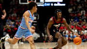 Cincinnati Bearcats guard Day Day Thomas (1) handles the ball as Dayton Flyers forward Nate Santos (2) guards him in the first half of the NCAA men's basketball game between the Dayton Flyers and Cincinnati Bearcats at Heritage Bank Center in Cincinnati on Saturday, Dec. 16, 2023.