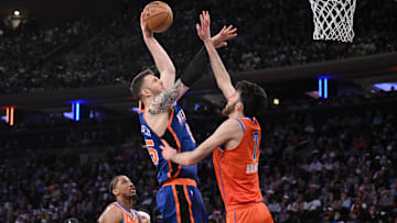 Mar 31, 2024; New York, New York, USA; New York Knicks center Isaiah Hartenstein (55) shoots the ball while being defended by Oklahoma City Thunder forward Chet Holmgren (7) and Oklahoma City Thunder guard Aaron Wiggins (21) during the second quarter at Madison Square Garden. Mandatory Credit: John Jones-Imagn Images