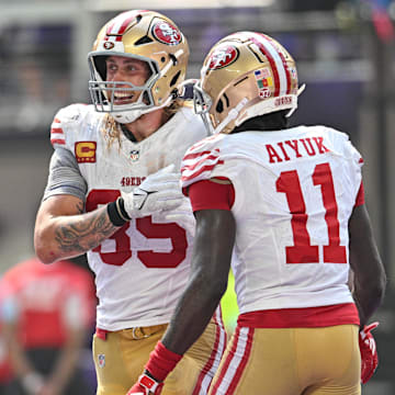 Sep 15, 2024; Minneapolis, Minnesota, USA; San Francisco 49ers tight end George Kittle (85) and wide receiver Brandon Aiyuk (11) react after a touchdown by Kittle during the second quarter against the Minnesota Vikings U.S. Bank Stadium. Mandatory Credit: Jeffrey Becker-Imagn Images