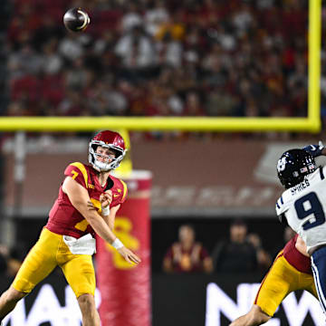 Sep 7, 2024; Los Angeles, California, USA; USC Trojans quarterback Miller Moss (7) throws a pass against the Utah State Aggies during the second quarter at United Airlines Field at Los Angeles Memorial Coliseum.