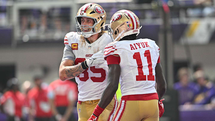 Sep 15, 2024; Minneapolis, Minnesota, USA; San Francisco 49ers tight end George Kittle (85) and wide receiver Brandon Aiyuk (11) react after a touchdown by Kittle during the second quarter against the Minnesota Vikings U.S. Bank Stadium. Mandatory Credit: Jeffrey Becker-Imagn Images