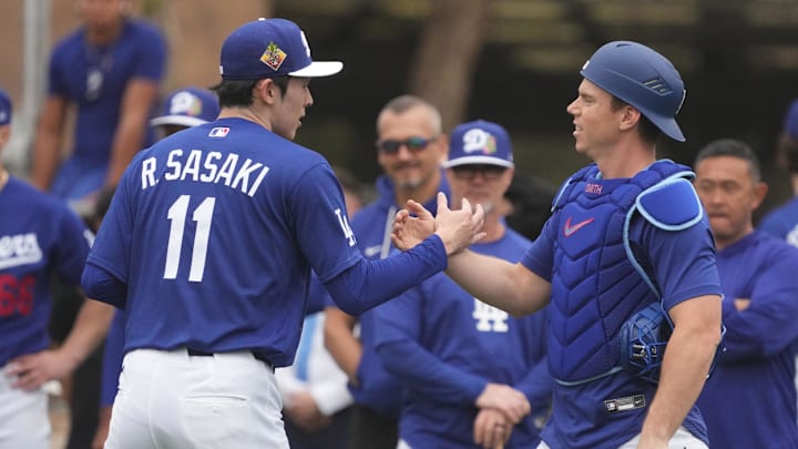 Feb 13, 2026; Glendale, AZ, USA; Los Angeles Dodgers pitcher Roki Sasaki (11) talks to catcher Will Smith (16) during spring training camp. Mandatory Credit: Rick Scuteri-Imagn Images