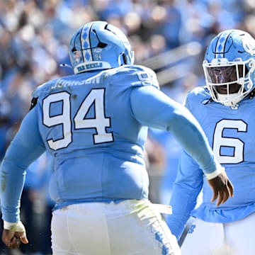 Oct 25, 2025; Chapel Hill, North Carolina, USA;  North Carolina Tar Heels defensive lineman Isaiah Johnson (94) celebrtates with defensive tackle D'Antre Robinson (6) after making a sack in the second quarer at Kenan Stadium. Mandatory Credit: Bob Donnan-Imagn Images