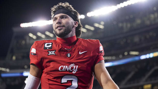 Cincinnati quarterback Brendan Sorsby walks off the field after defeating the Baylor Bears.