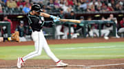 Jun 30, 2024; Phoenix, Arizona, USA; Arizona Diamondbacks pinch hitter Blaze Alexander (9) hits a two RBI single against the Oakland Athletics during the seventh inning at Chase Field. Mandatory Credit: Joe Camporeale-Imagn Images
