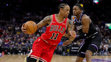 Mar 14, 2022; Sacramento, California, USA; Chicago Bulls forward DeMar DeRozan (11) dribbles the ball around Sacramento Kings guard De'Aaron Fox (5) during the third quarter at Golden 1 Center. Mandatory Credit: Sergio Estrada-Imagn Images