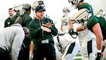 Michigan State's head coach Jonathan Smith, left, talks with Justin Bell during football practice on Tuesday, April 8, 2025, in East Lansing.