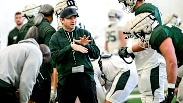 Michigan State's head coach Jonathan Smith, left, talks with Justin Bell during football practice on Tuesday, April 8, 2025, in East Lansing.