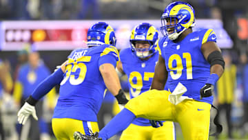 Los Angeles Rams defensive tackle Braden Fiske (55), linebacker Michael Hoecht (97) and defensive tackle Kobie Turner (91) celebrate after a sack at SoFi Stadium.