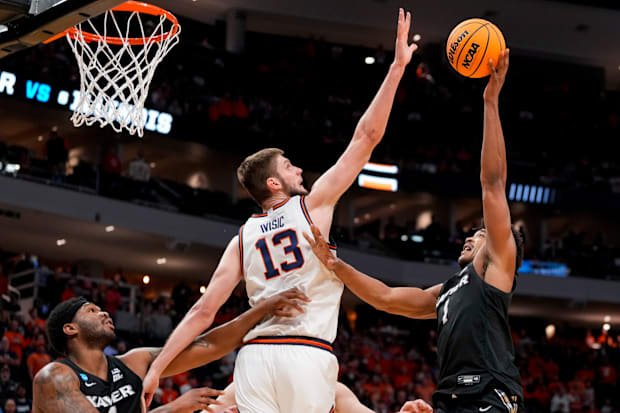 Illinois center Tomislav Ivisic blocks a shot by Xavier guard Marcus Foster in the first round of the NCAA tournament.