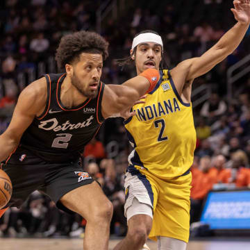 Mar 20, 2024; Detroit, Michigan, USA; Detroit Pistons guard Cade Cunningham (2) drives to the basket next to Indiana Pacers guard Andrew Nembhard (2) in the first half at Little Caesars Arena. Mandatory Credit: David Reginek-USA TODAY Sports