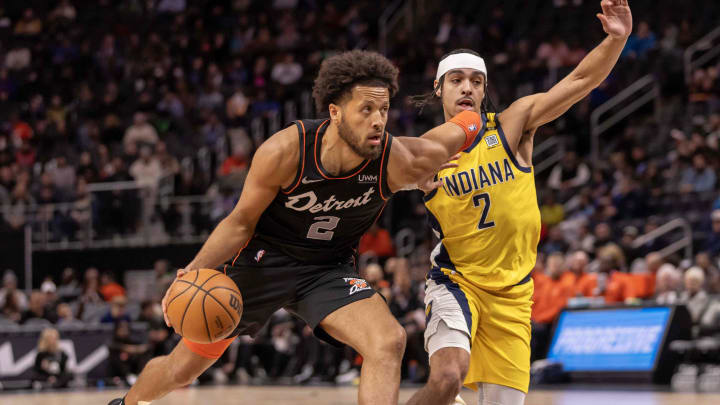 Mar 20, 2024; Detroit, Michigan, USA; Detroit Pistons guard Cade Cunningham (2) drives to the basket next to Indiana Pacers guard Andrew Nembhard (2) in the first half at Little Caesars Arena. Mandatory Credit: David Reginek-USA TODAY Sports