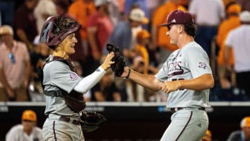 Jun 22, 2024; Omaha, NE, USA; Texas A&M Aggies pitcher Evan Aschenbeck (53) and  catcher Jackson Appel (20) celebrate after defeating the Tennessee Volunteers at Charles Schwab Field Omaha. Mandatory Credit: Dylan Widger-USA TODAY Sports