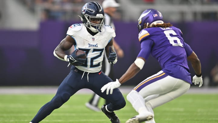 Aug 19, 2023; Minneapolis, Minnesota, USA; Tennessee Titans running back Tyjae Spears (32) runs the ball as Minnesota Vikings safety Lewis Cine (6) looks to make the tackle during the first quarter at U.S. Bank Stadium.