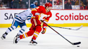 Apr 18, 2024; Calgary, Alberta, CAN; Calgary Flames center Nazem Kadri (91) skates with the puck against the San Jose Sharks during the third period at Scotiabank Saddledome. Mandatory Credit: Sergei Belski-USA TODAY Sports