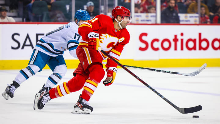 Apr 18, 2024; Calgary, Alberta, CAN; Calgary Flames center Nazem Kadri (91) skates with the puck against the San Jose Sharks during the third period at Scotiabank Saddledome. Mandatory Credit: Sergei Belski-USA TODAY Sports