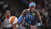Atlanta Dream guard Rhyne Howard dribbles with the ball.
