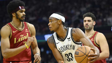 Mar 10, 2024; Cleveland, Ohio, USA; Brooklyn Nets center Nic Claxton (33) looks to pass between Cleveland Cavaliers center Jarrett Allen (31) and forward Georges Niang (20) in the second quarter at Rocket Mortgage FieldHouse. Mandatory Credit: David Richard-USA TODAY Sports