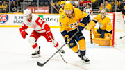 Oct 19, 2024; Nashville, Tennessee, USA; Nashville Predators center Jonathan Marchessault (81) skates as Detroit Red Wings right wing Alex DeBrincat (93) pokes at the puck during the second period at Bridgestone Arena. Mandatory Credit: Steve Roberts-Imagn Images