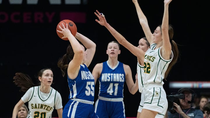 Newell-Fonda's Jocee Walsh looks to pass the ball against Council Bluffs St. Albert's Molly Wise (22) and Avah Underwood (40) during the 1A IGHSAU state basketball championship at Wells Fargo Arena on Saturday, March 8, 2025, in Des Moines.
