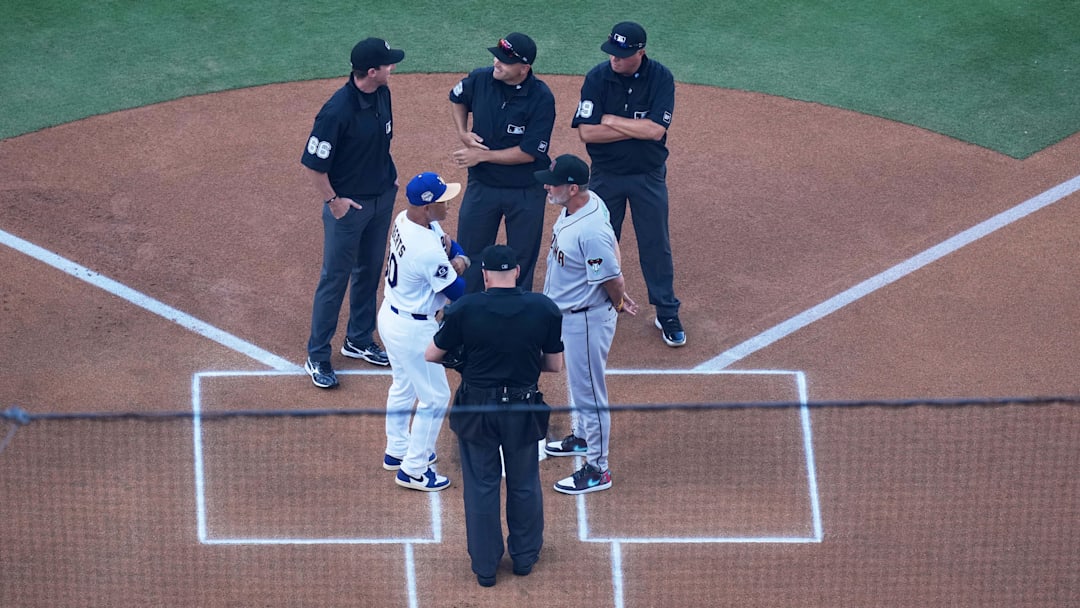 Mar 26, 2026; Los Angeles, California, USA; Los Angeles Dodgers manager Dave Roberts (30) and Arizona Diamondbacks manager Torey Lovullo (17) exchange lineup cards before the game as umpires Andy Fletcher (49), Cory Blaser (89), Jansen Visconti (52) and Alex Tosi (66) look on at Dodger Stadium. Mandatory Credit: Kirby Lee-Imagn Images