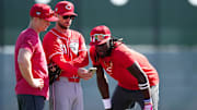 Cincinnati Reds shortstop Matt McLain (9), bench coach Jeff Pickler and shortstop Elly De La Cruz (44) review notes during spring training workouts, Wednesday, Feb. 14, 2024, at the team’s spring training facility in Goodyear, Ariz.