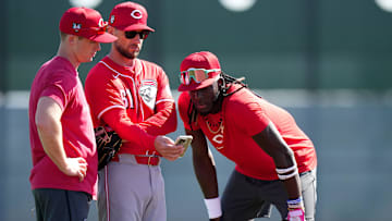 Cincinnati Reds shortstop Matt McLain (9), bench coach Jeff Pickler and shortstop Elly De La Cruz (44) review notes during spring training workouts, Wednesday, Feb. 14, 2024, at the team’s spring training facility in Goodyear, Ariz.