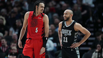 Apr 6, 2025; Portland, Oregon, USA; Portland Trail Blazers guard Dalano Banton (5) and San Antonio Spurs point guard Jordan McLaughlin (11) talk during the second half at Moda Center. Mandatory Credit: Soobum Im-Imagn Images