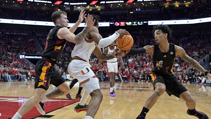 Feb 8, 2025; Louisville, Kentucky, USA;  Louisville Cardinals guard Terrence Edwards Jr. (5) and guard Reyne Smith (6) pressure Miami (Fl) Hurricanes guard A.J. Staton-McCray (11) during the first half at KFC Yum! Center. Mandatory Credit: Jamie Rhodes-Imagn Images
