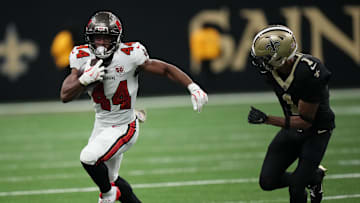 Oct 26, 2025; New Orleans, Louisiana, USA; Tampa Bay Buccaneers running back Sean Tucker (44) runs for a gain past New Orleans Saints cornerback Alontae Taylor (1) during the fourth quarter at Caesars Superdome. Mandatory Credit: Matthew Hinton-Imagn Images