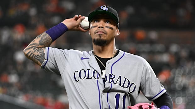 Colorado Rockies third baseman Orlando Arcia in a gray uniform and black hat
